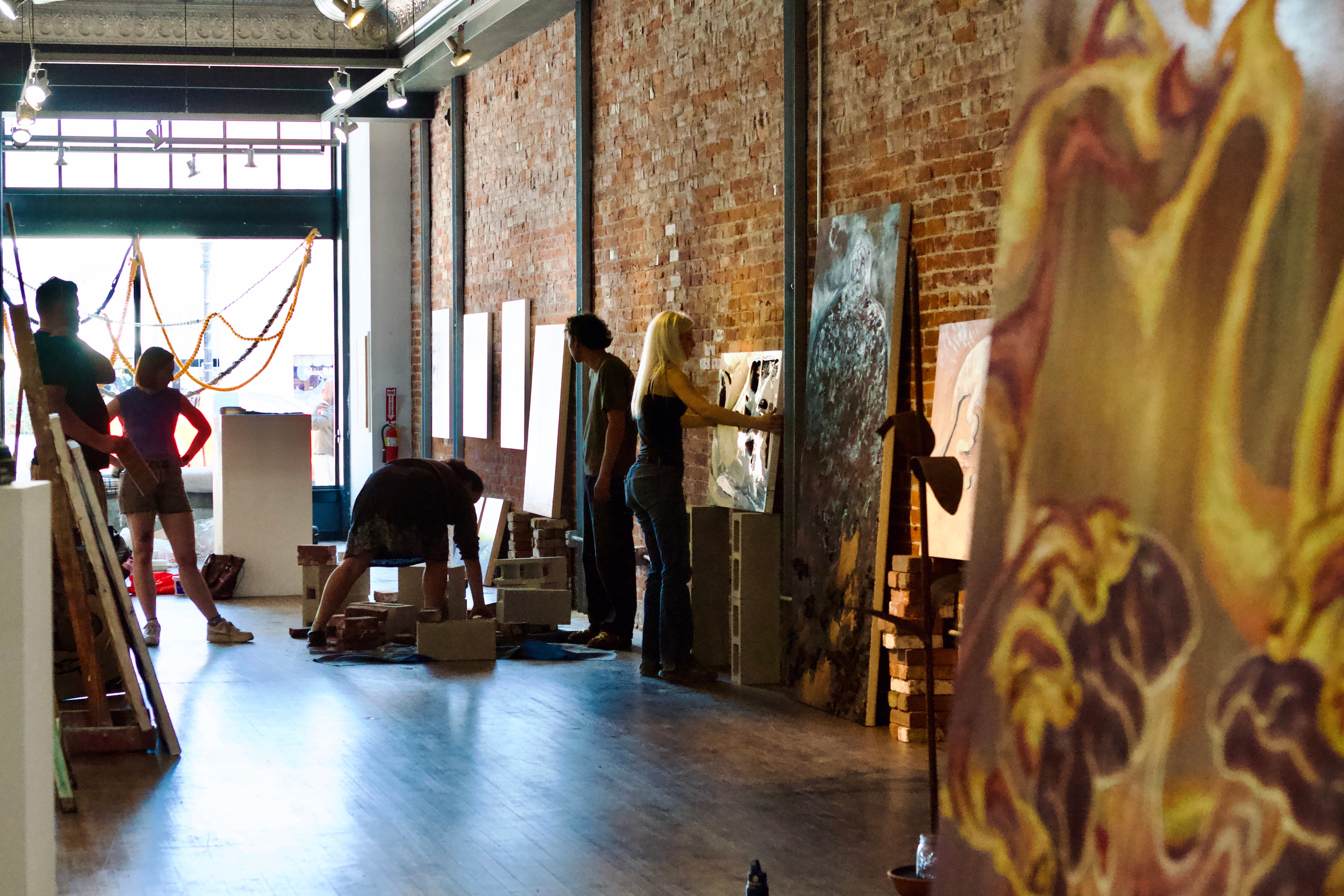 Students prepare artwork for an exhibition at local art gallery