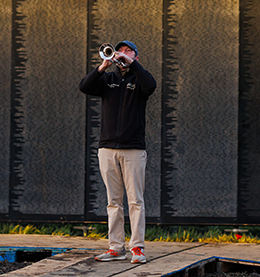Chris Woodruff sounds taps at the memorial.