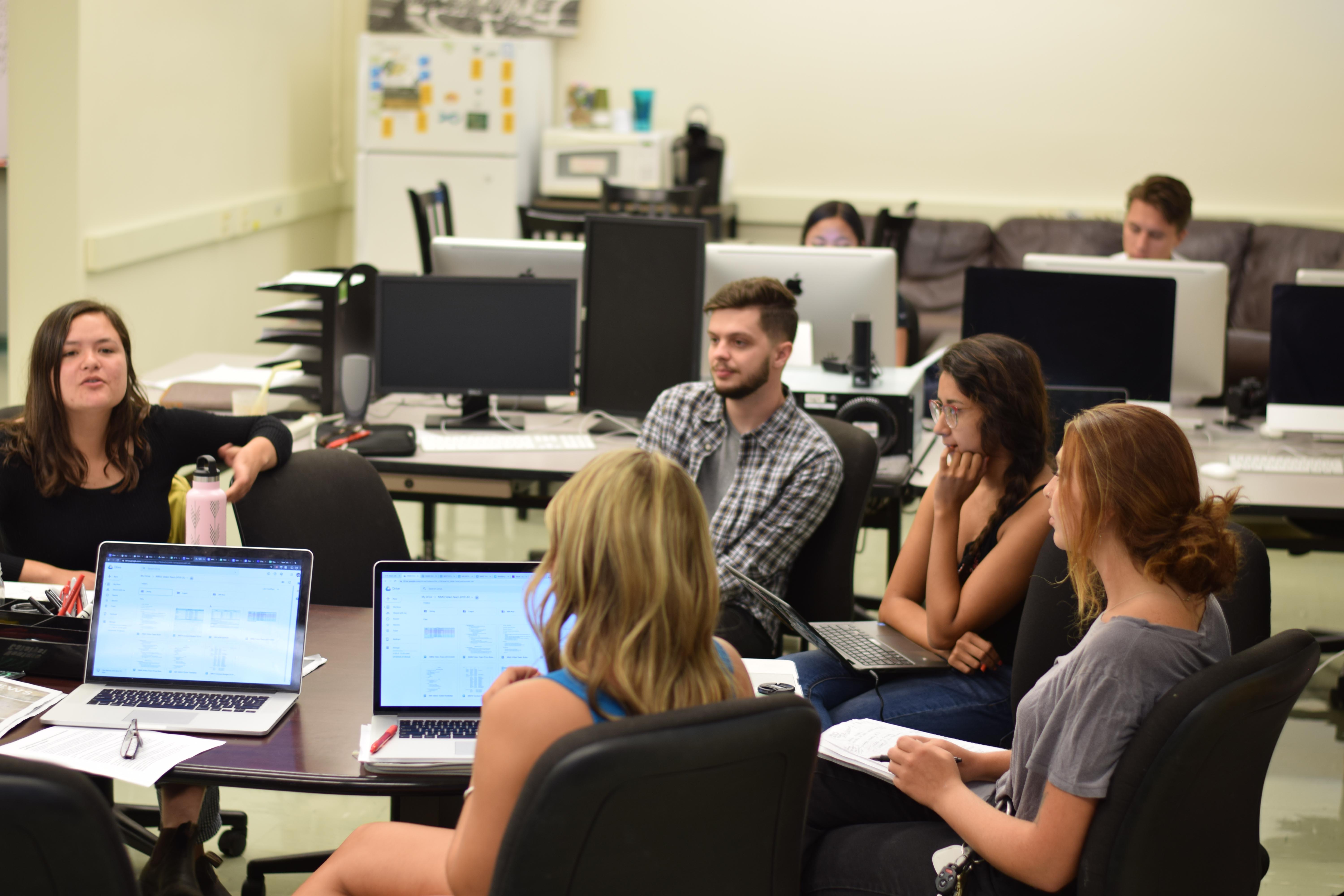 Editors and reports in the paper's newsroom