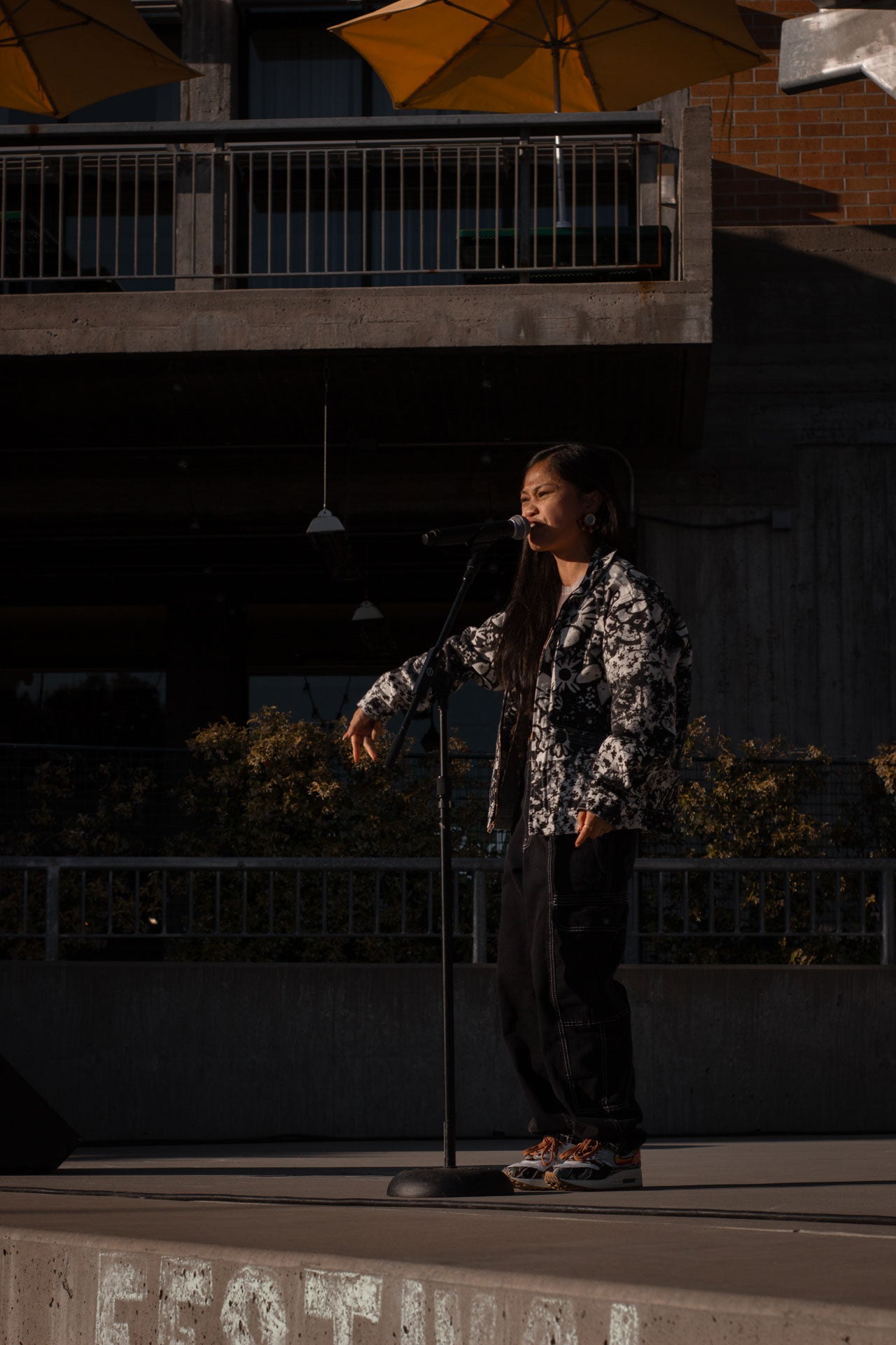 Ruby Ibarra, wearing a black and white jacket, performing solo on the University Union Stage Ruby Ibarra, wearing a black and white jacket, performing solo on the University Union Stage