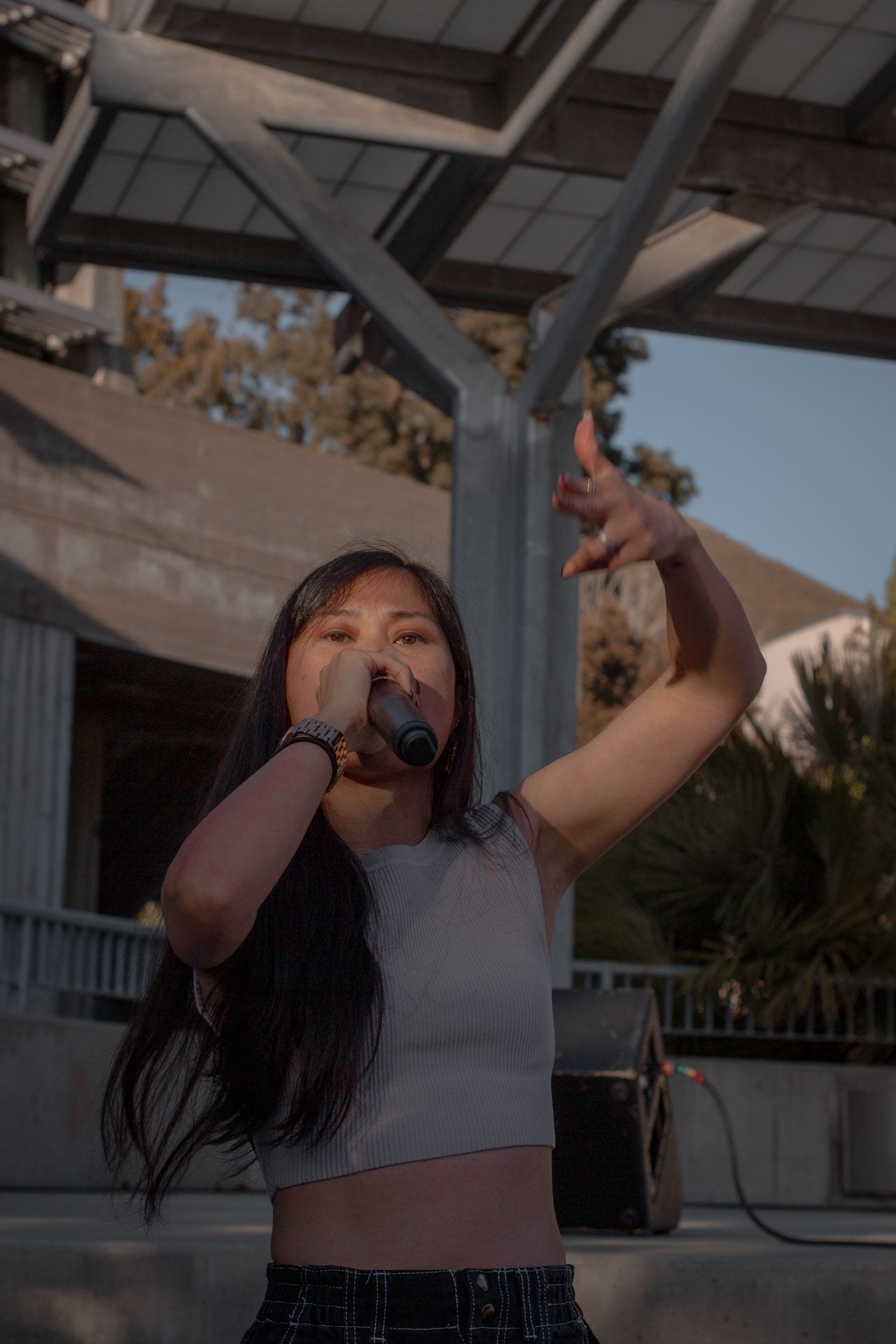 A close up of Ruby Ibarra, wearing a tan crop top, singing to the crowd A close up of Ruby Ibarra, wearing a tan crop top, singing to the crowd
