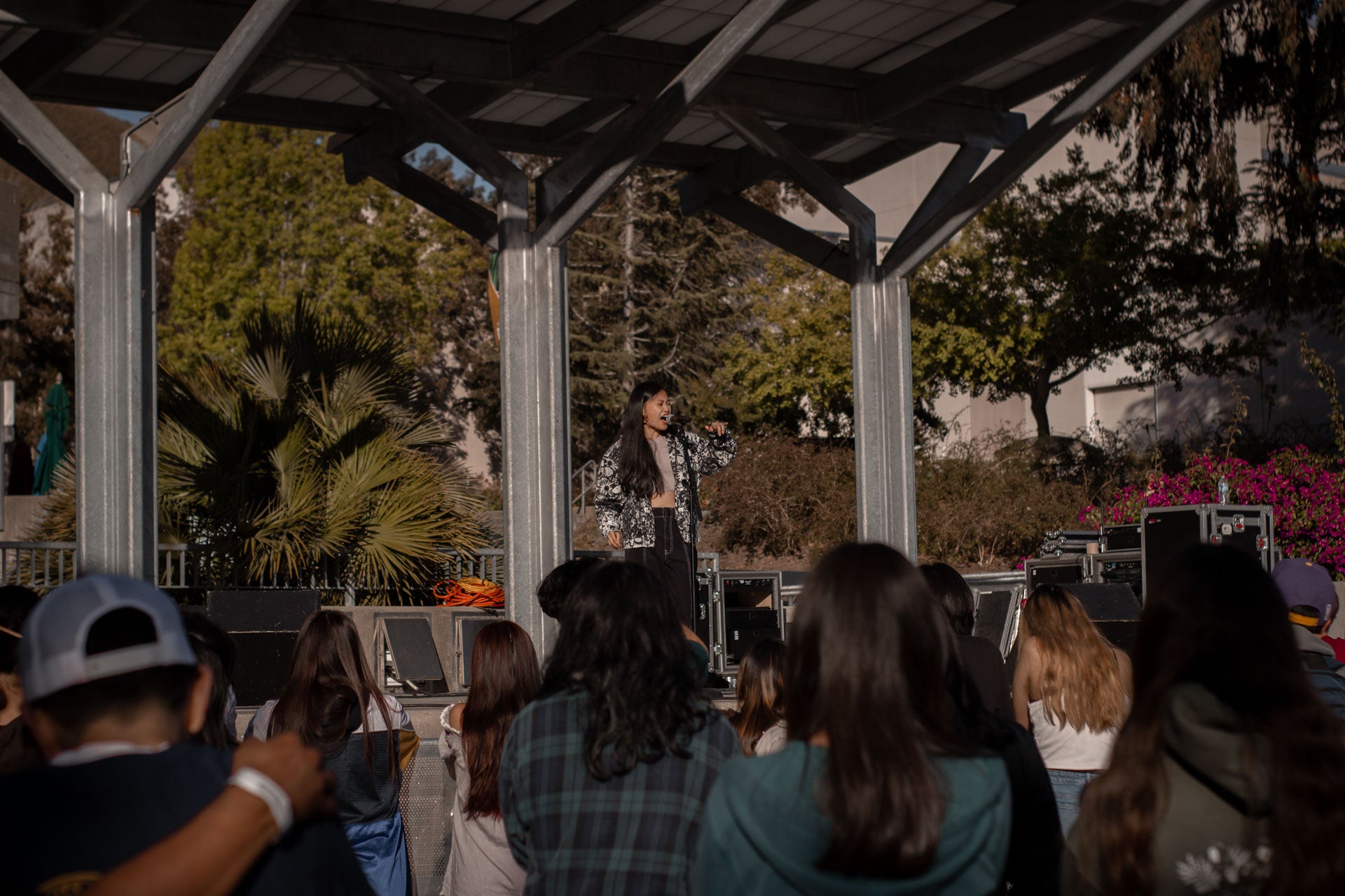 Ruby Ibarra, performing on stage, with concert-goers in the foreground Ruby Ibarra, performing on stage, with concert-goers in the foreground