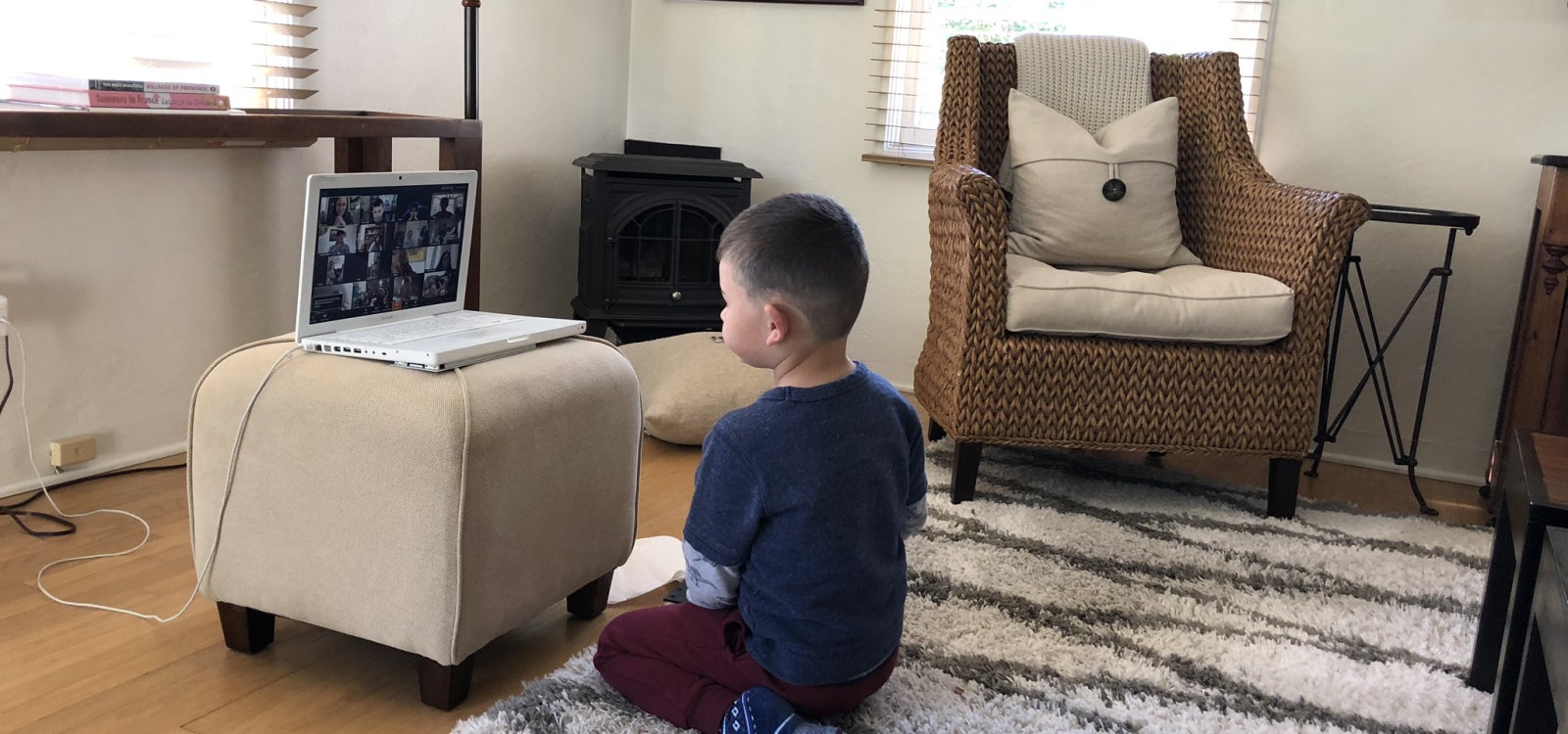 Preschool student Edro sits in front of a laptop during one of the Preschool Learning Lab's virtual sessions. Courtesy of Peggy Osborn