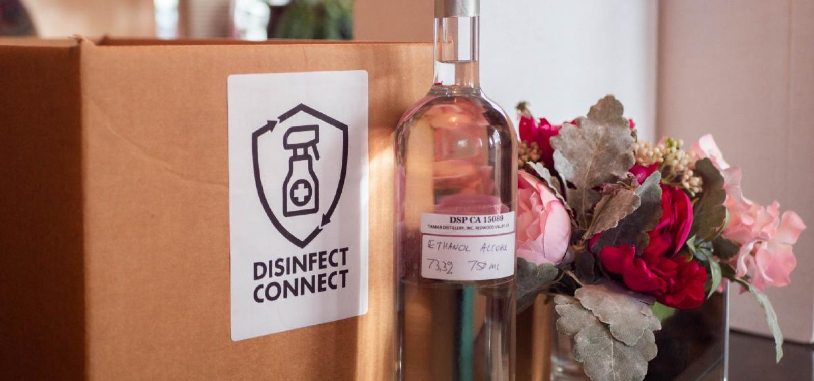 A bottle of hand sanitizer with Disinfect Connect's logo in the background