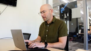 Professor Matt Harsh working on a laptop at Kennedy Library