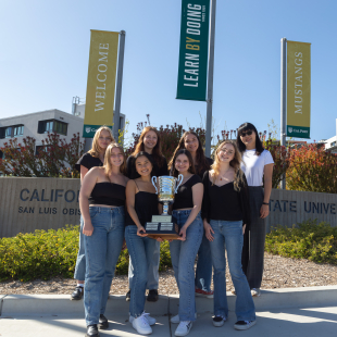 The TAGA executive board, alongside faculty advisor Rachel Ma, pose for a group photo with the Helmut Kipphan Cup.