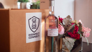 A bottle of hand sanitizer with Disinfect Connect's logo in the background