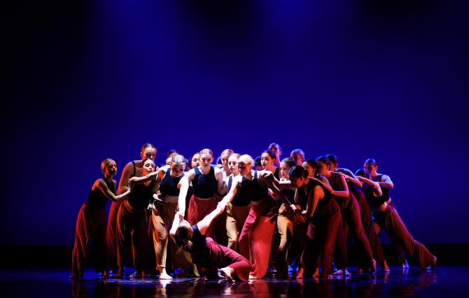A group of dance students performing on stage