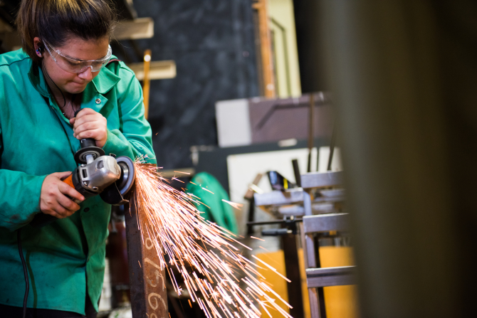 Student welding a component of a theatre performance