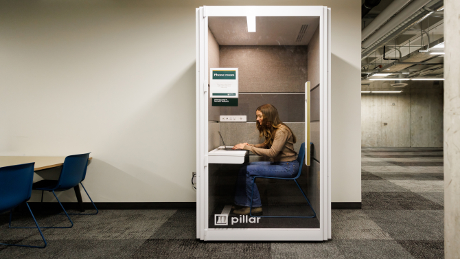 Student in front of a laptop in the library