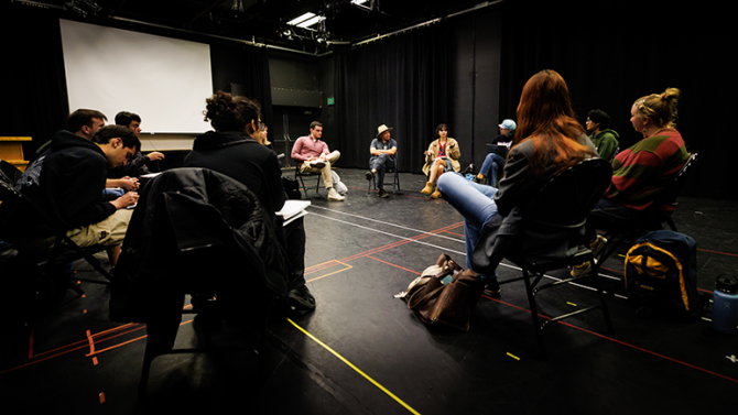 Students sitting in a circle for a theatre class