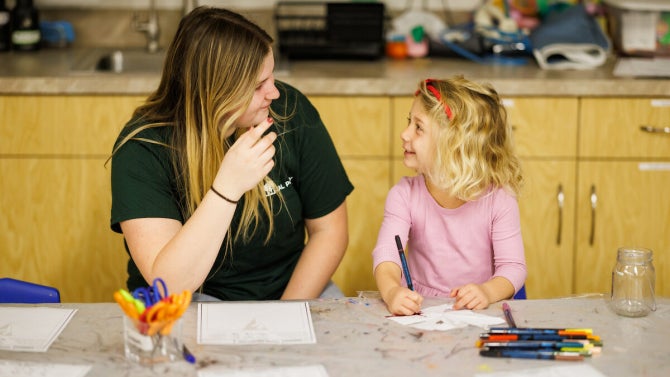 Cal Poly student work with children at the Orfalea Family and ASI Children’s Center.