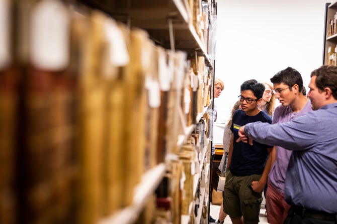People looking at books in a library