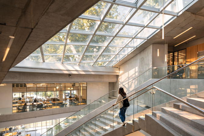 Person walking down stairs in a building