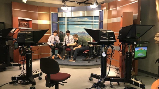 Three people in a television studio