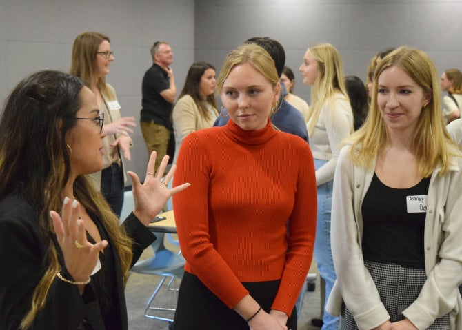 Journalism students chatting with internship supervisor