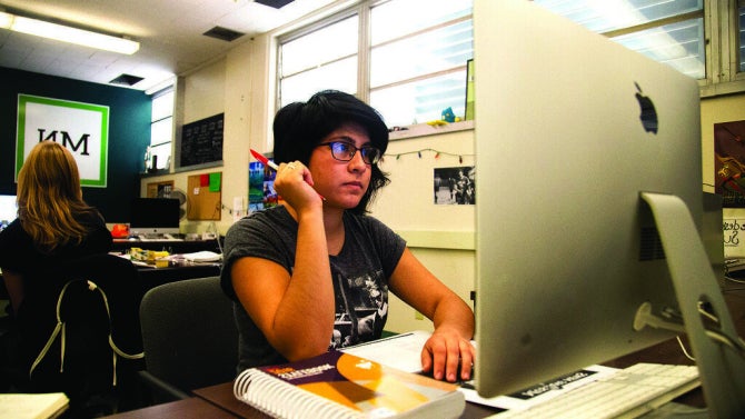 Mustang News editor in the newsroom