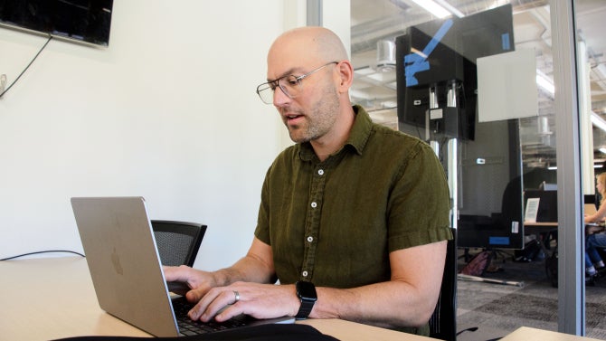 Professor Matt Harsh working on a laptop at Kennedy Library